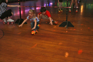 Students doing the Limbo in skates at our last roller skating party. 