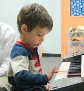 3 year old playing keyboard in Music Wonderland