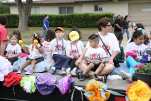Jensen's Yamaha Students waving and singing on our fiesta float in the Castle Hills Fiesta Parade.