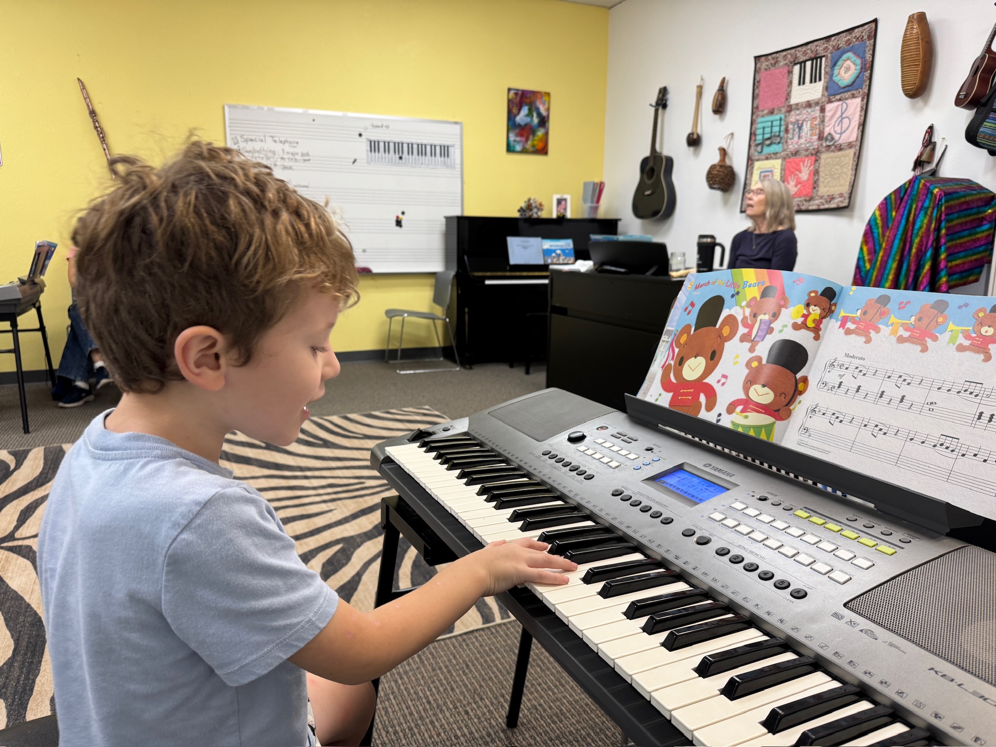 5 year old child playing the keyboard in a group