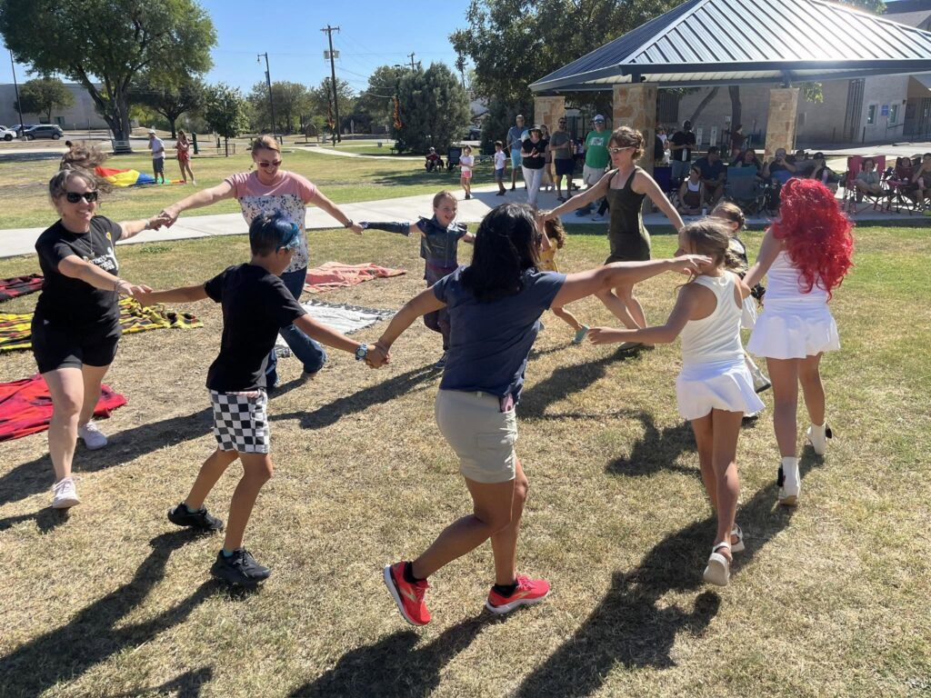 group of people in the park dancing
